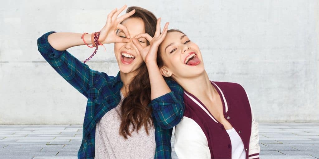 two young teen girls goofing off