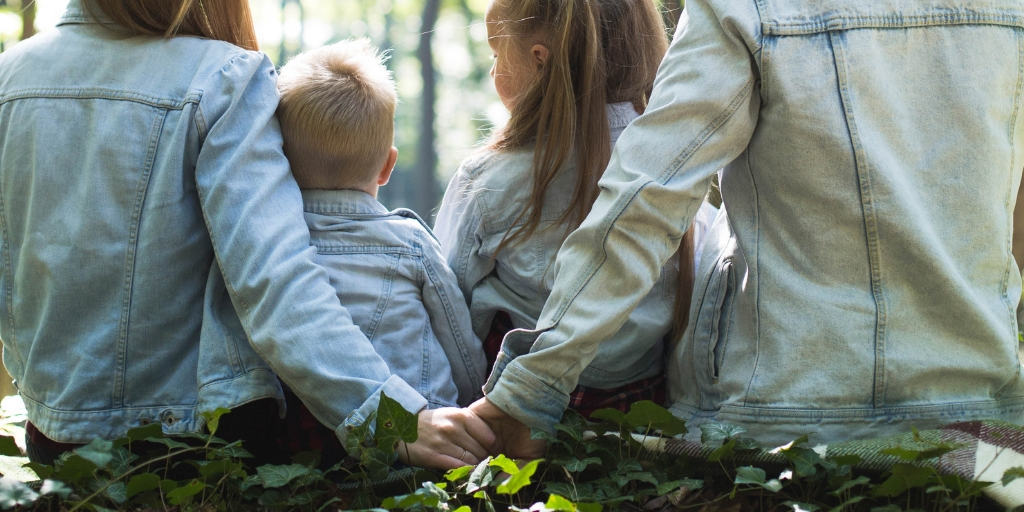 family in the woods, father and mother holding hands