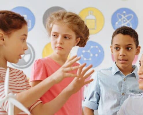 three kids and one adult, kids are talking about money