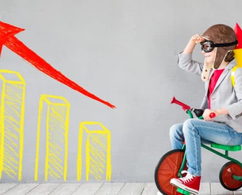 boy kid on a bicycle with a business chart on his left, looking to the future of kids business games