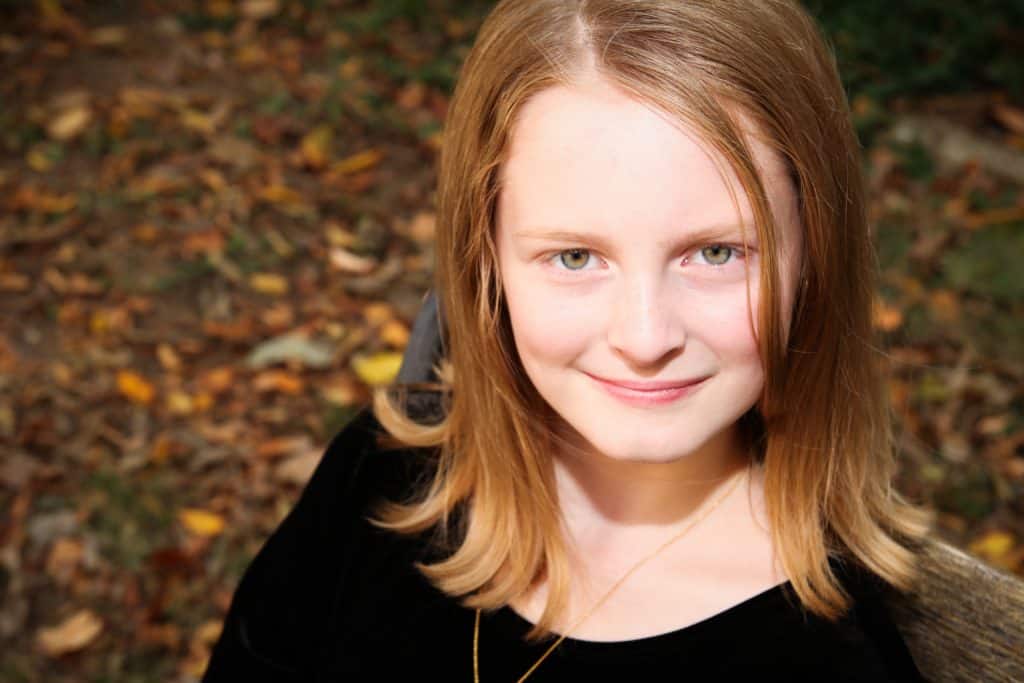 red-headed, 10 year old girl smiling in camera