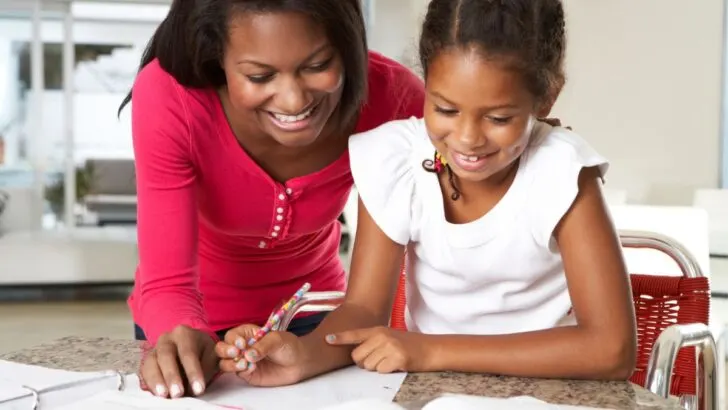 entrepreneur mother working with child at home on desk