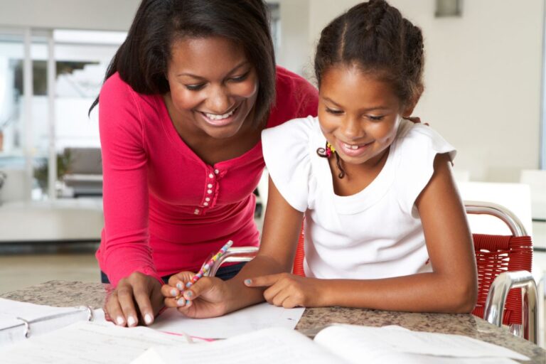 entrepreneur mother working with child at home on desk
