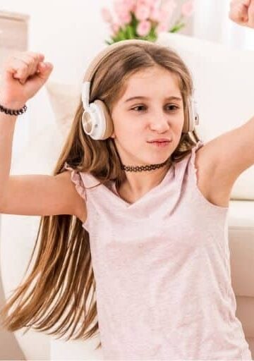 young teen dancing with headphones on