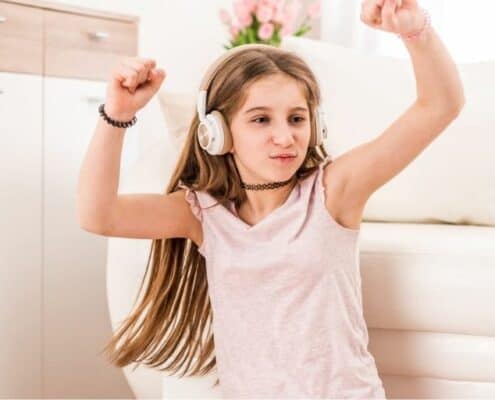 young teen dancing with headphones on