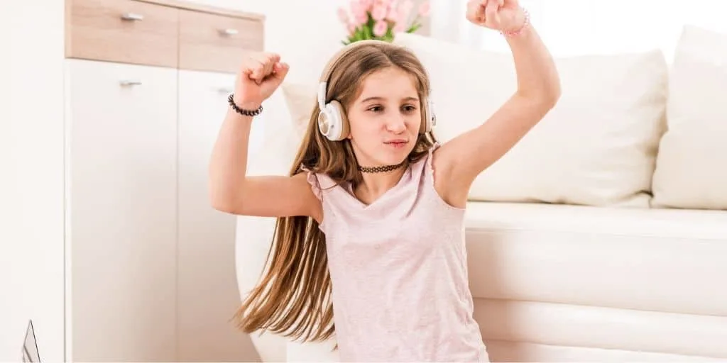 young teen dancing with headphones on