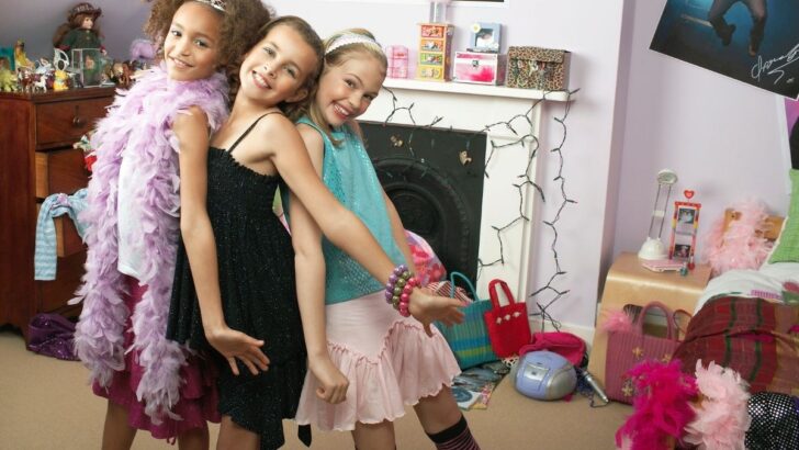 three preteen girls playing dress up and having fun
