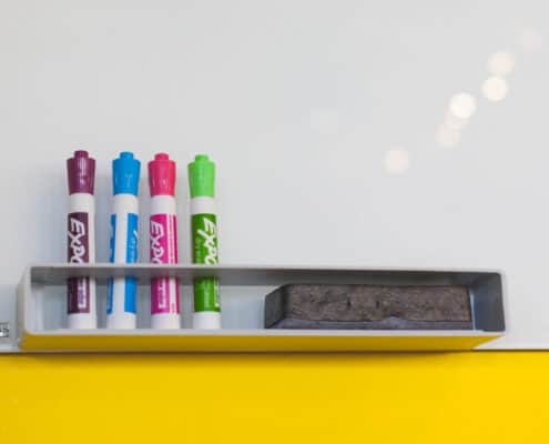 white board on yellow painted wall background, used as a vision board for kids