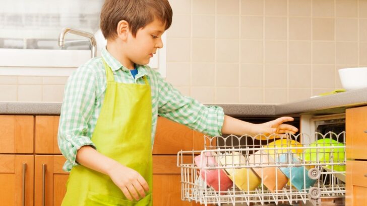 boy unloading dishwasher