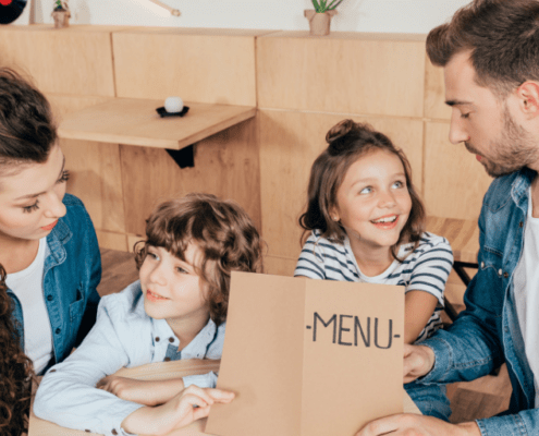 family in a restaurant with a menu, getting ready to order