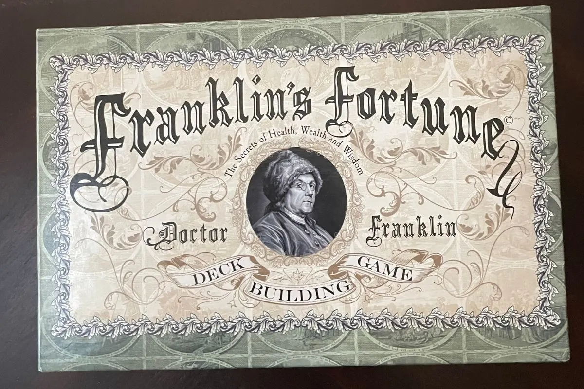 antique-looking font on board game box with ben franklin in center