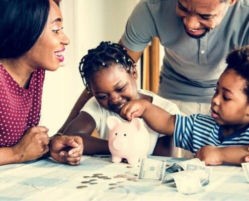 young family at kitchen table, doing money activities with kids