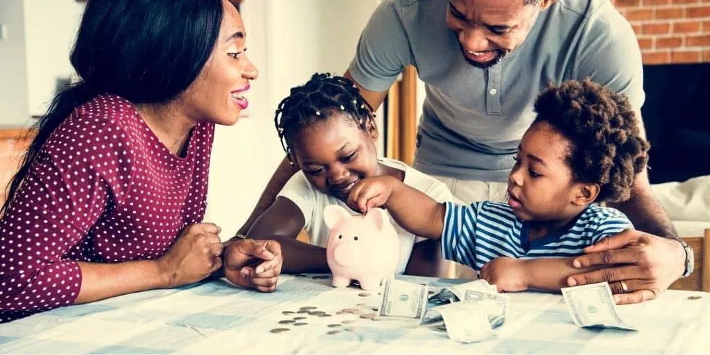 young family at kitchen table, doing money activities with kids