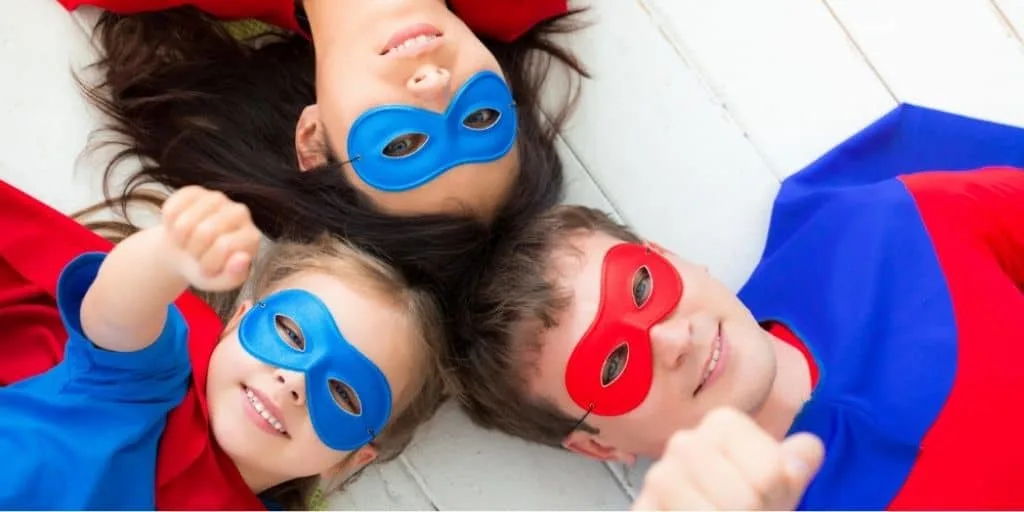 family of super heroes looking at up camera