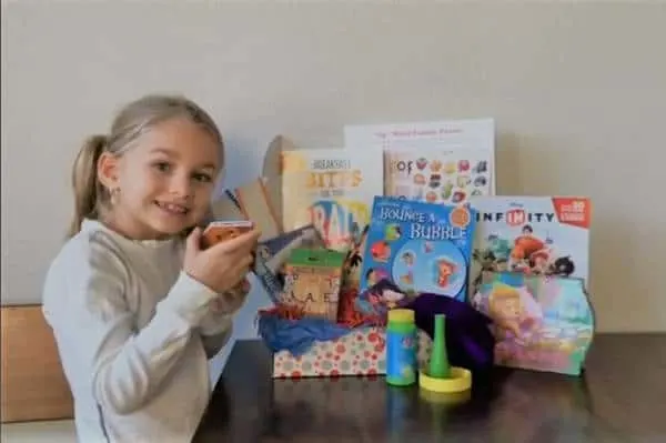 learning crates kid subscription box review with a young girl, next to bubbles and books
