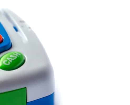 cash register for kids in the left corner on white background
