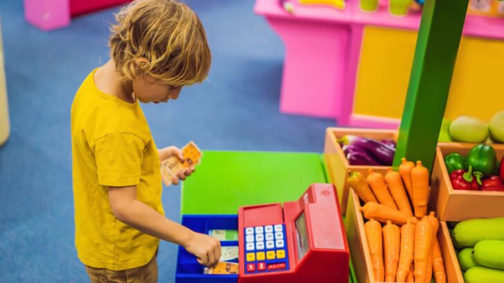 boy playing with cash register