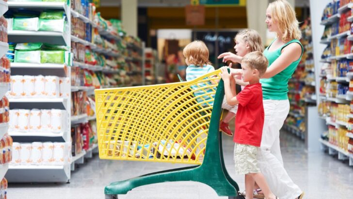 woman with three kids grocery shopping