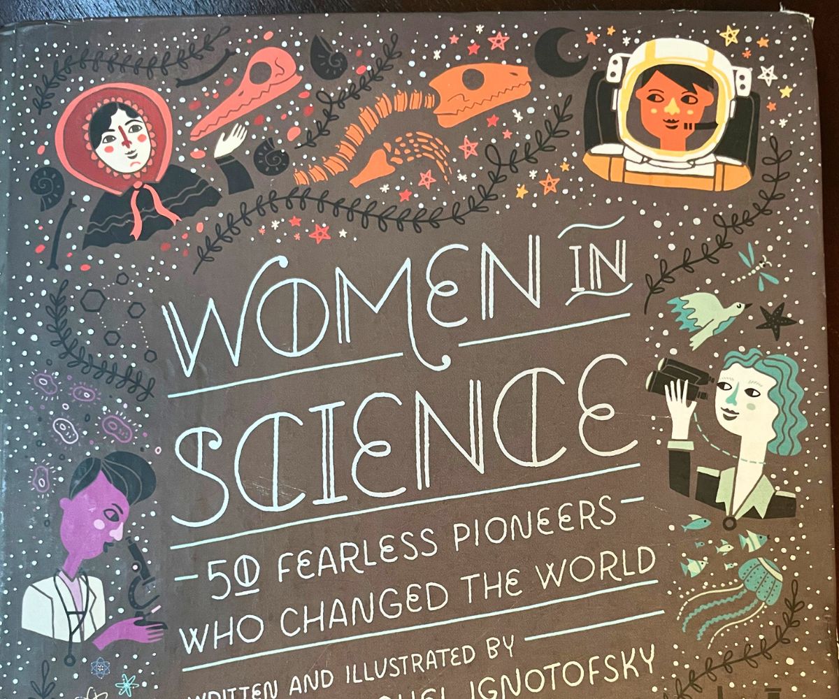 black cover Women in Science with hand drawn doodles and women portraits