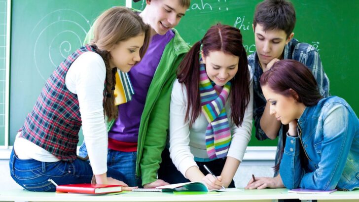 group of high school students working on entrepreneur project in class