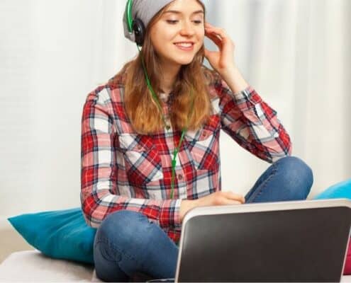 teen girl with laptop and headphones, making money at an online teen job