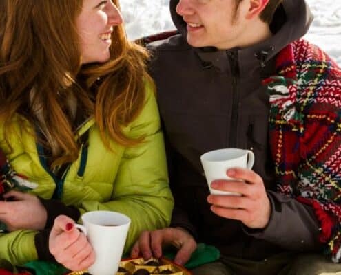 teenage couple with chocolate and hot cocoa, enjoying cute valentine's day date ideas