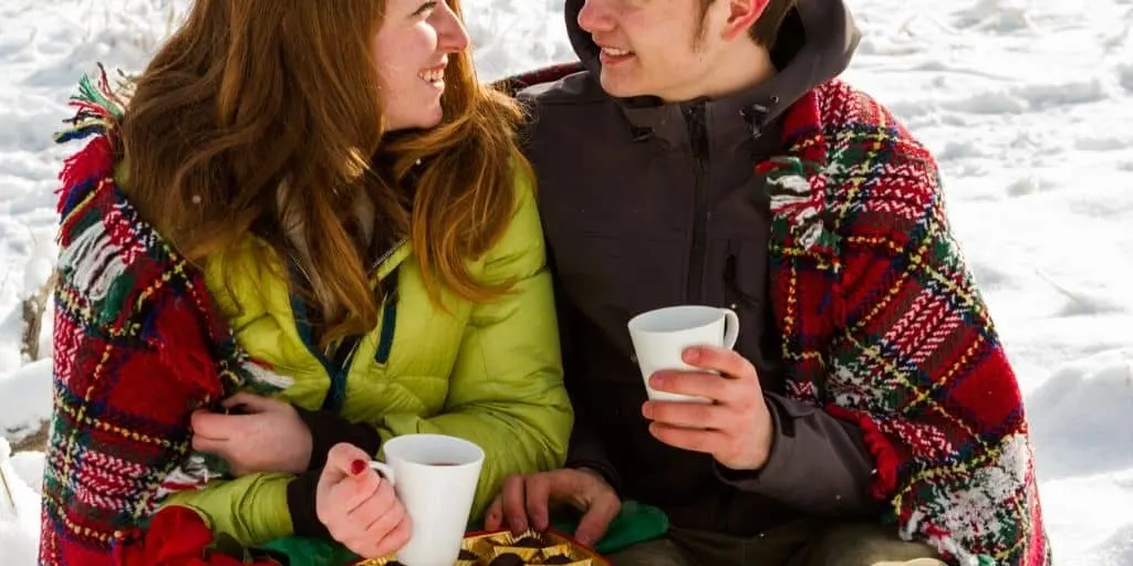 teenage couple with chocolate and hot cocoa, enjoying cute valentine's day date ideas