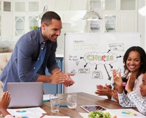 young family having meeting to pick chores for money chart