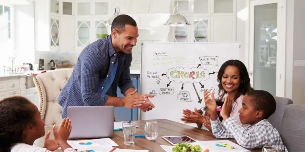 young family having meeting to pick chores for money chart