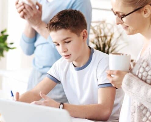 mother helping teenage son fill out sample budget template for teenager