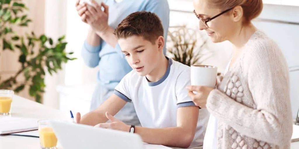 mother helping teenage son fill out sample budget template for teenager