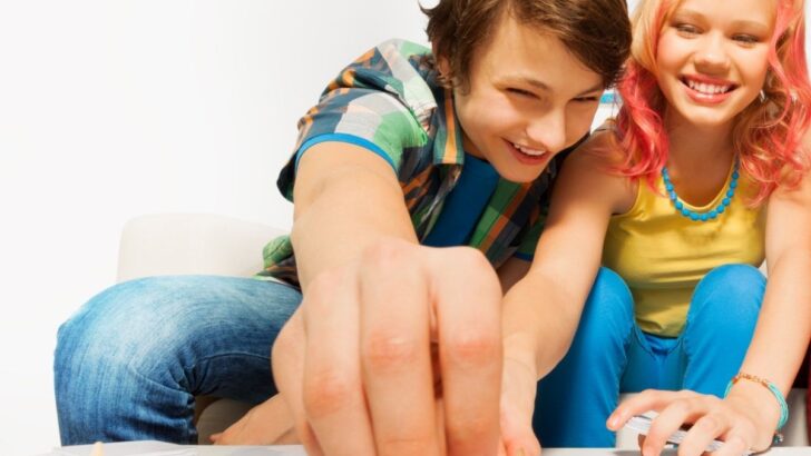 teen boy and girl having lots of fun playing a game
