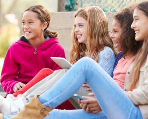 group of girl teenagers sitting and talking, maybe about money should i have saved by 18