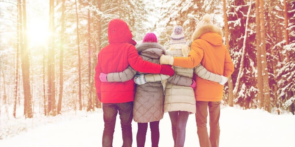 group of teen couples on double date in winter woods