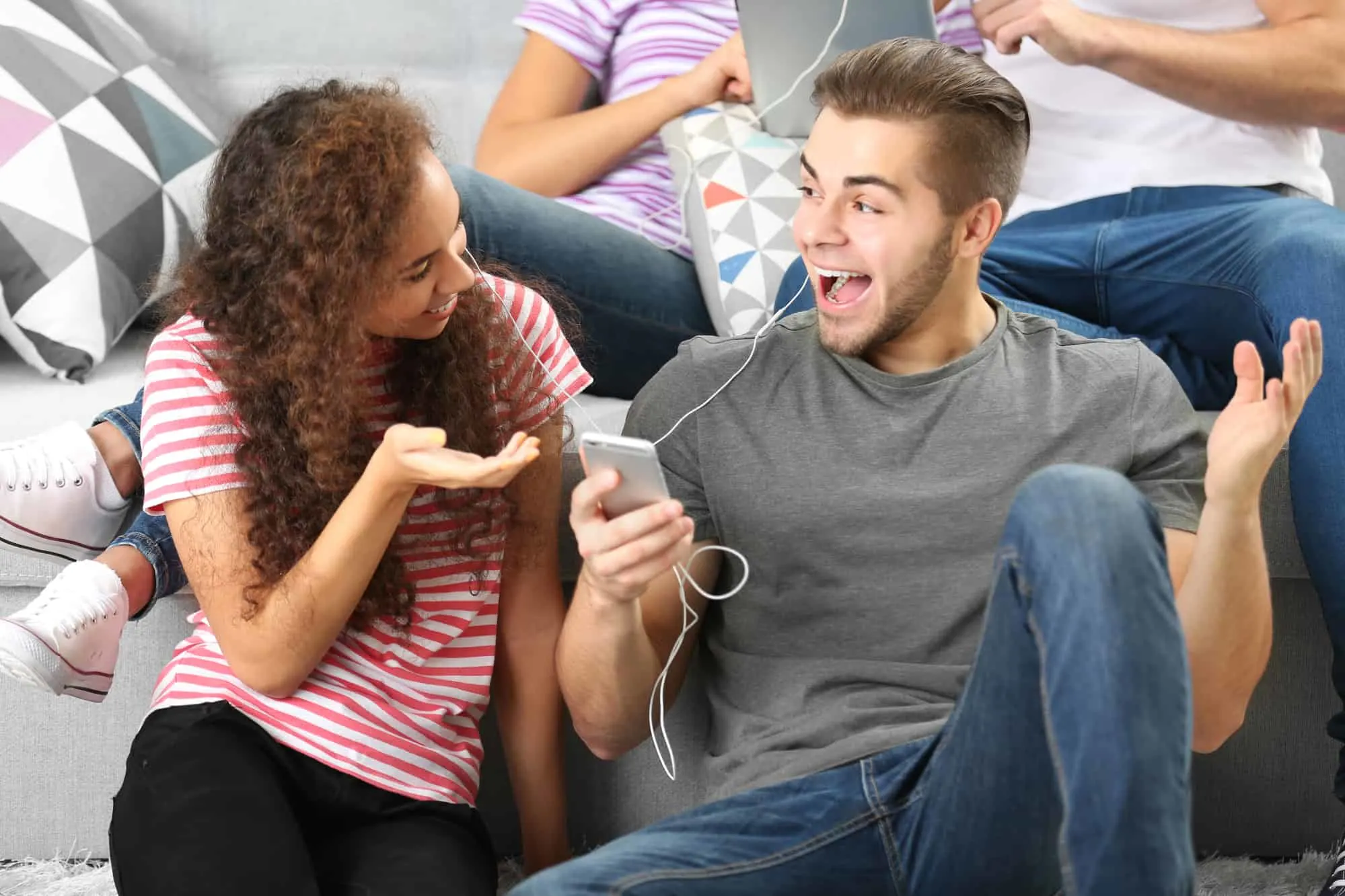 teenage couple at home date night, playing music roulette