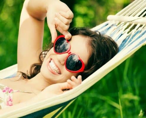 teen girl with sunglasses, on hammock, doing summer teen activities