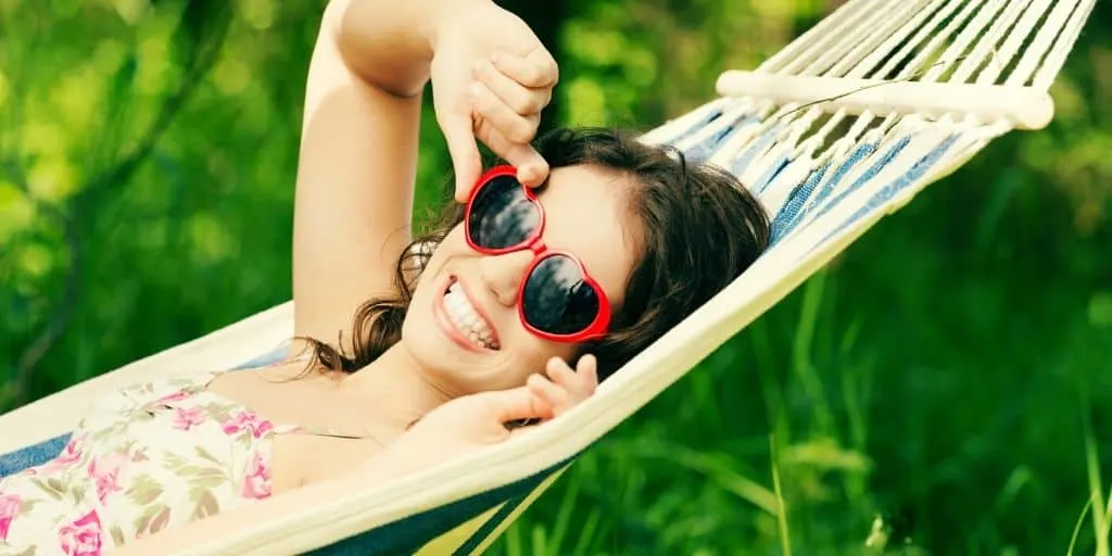 teen girl with sunglasses, on hammock, doing summer teen activities