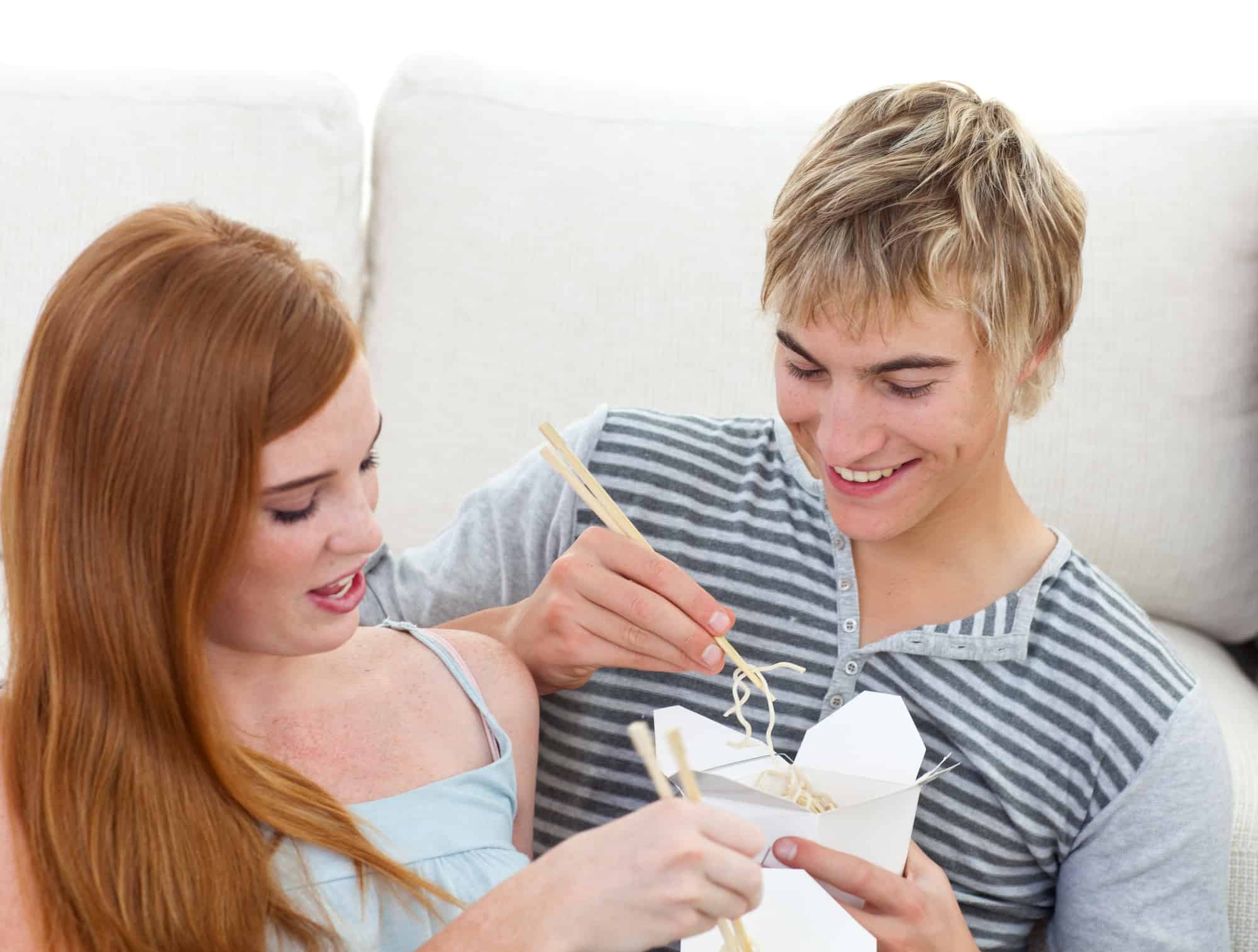 teenage couple on chopstick date night at home, wholesome date ideas