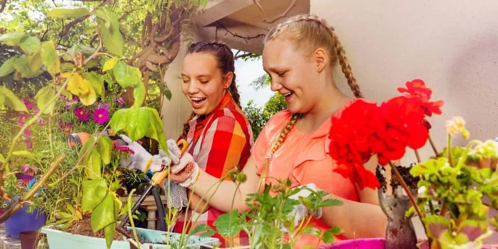 two teen girls working on a plant and flower kid business that makes money