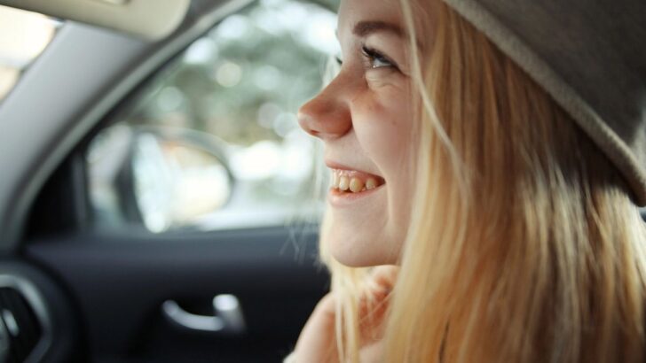 smiling girl new driver in car
