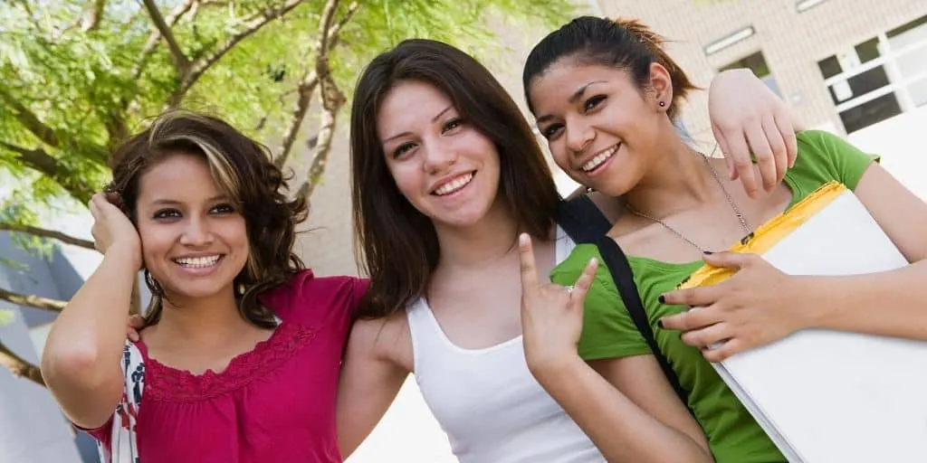 three smiling teenage girls wondering what are good goals for a teenager?