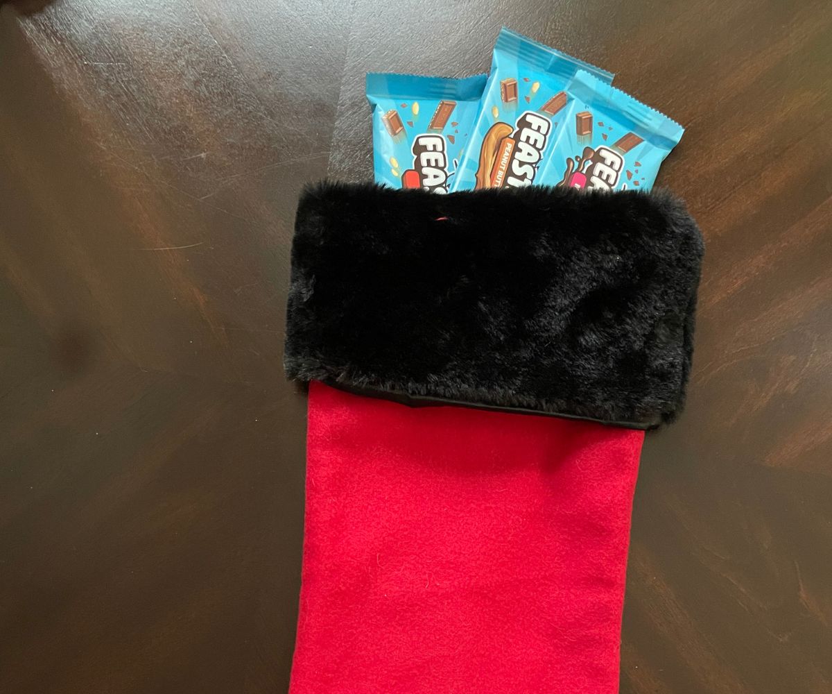 three bars of light blue Mr Beast Feastables in red and black Christmas stocking