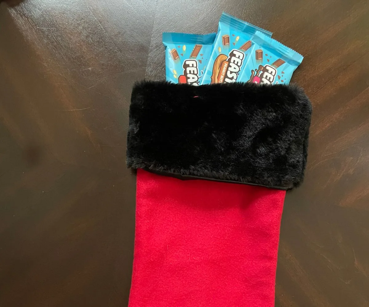 three bars of light blue Mr Beast Feastables in red and black Christmas stocking