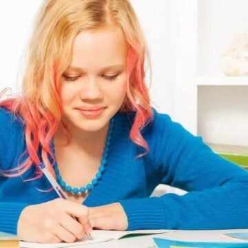 tween having fun at desk with money game printable for kids