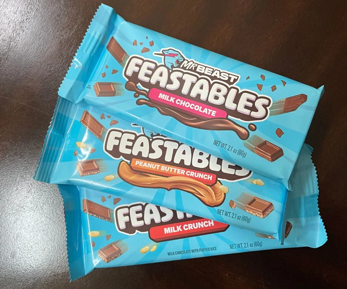 3 bars of Mr Beast Feastables chocolate on dark table