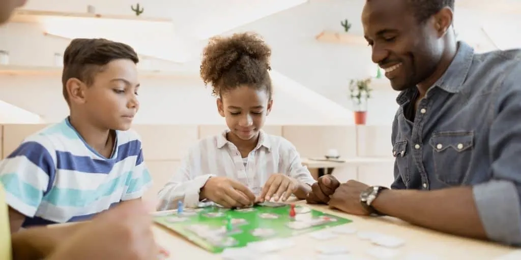 family playing a game about credit with kids to explain credit to a child