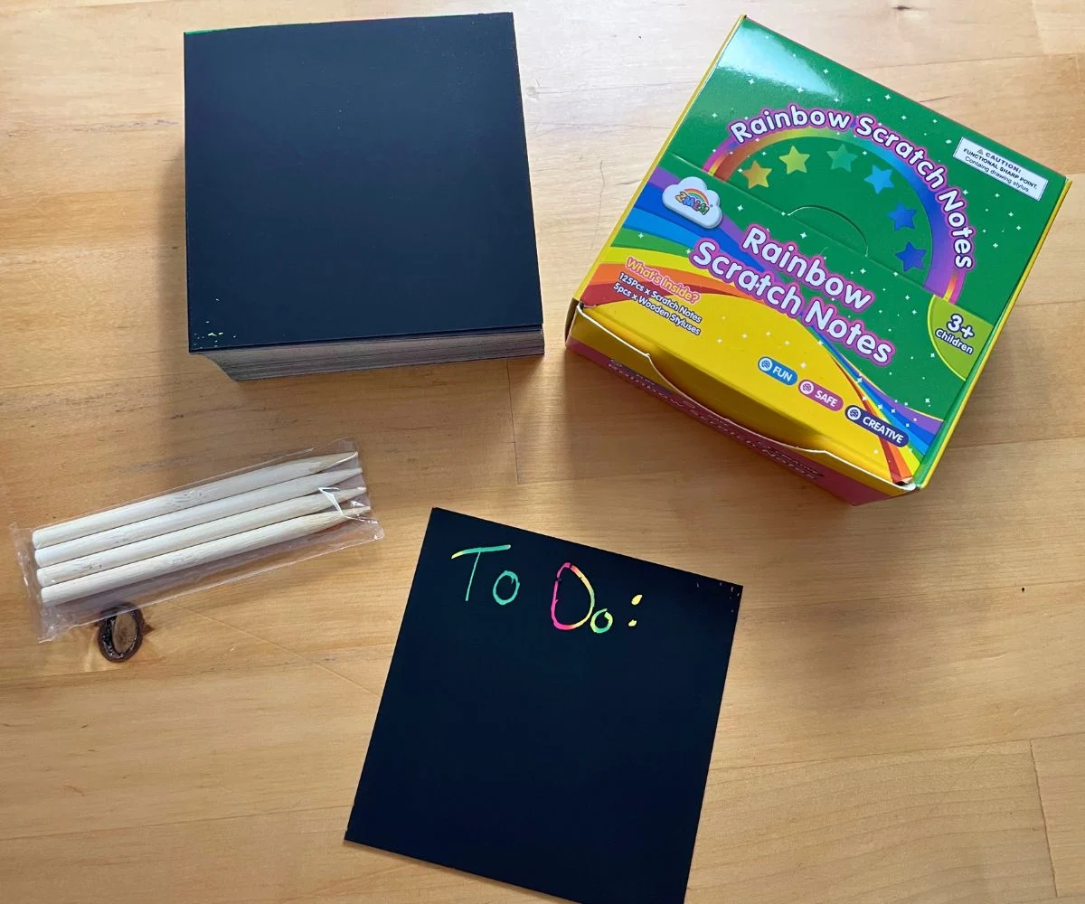black scratch notes with wooden stylus pens, and "To Do" written on top of one