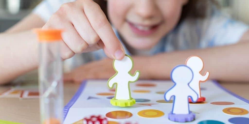 girl child playing a budgeting game for youth printable