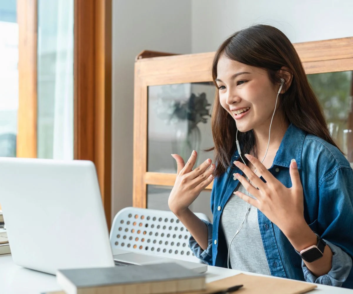 teen girl smiling with hands in air tutoring online