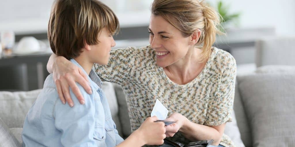 Mom with arm around son, giving him free printable reward bucks